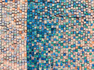 Detail of beautiful old collapsing abstract ceramic mosaic adorned building. Venetian mosaic as decorative background. Selective focus. Abstract Pattern. Abstract mosaic colored ceramic stones