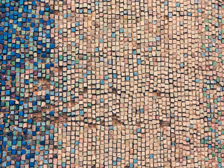 Detail of beautiful old collapsing abstract ceramic mosaic adorned building. Venetian mosaic as decorative background. Selective focus. Abstract Pattern. Abstract mosaic colored ceramic stones