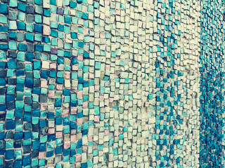 Fototapeta premium Detail of beautiful old collapsing abstract ceramic mosaic adorned building. Venetian mosaic as decorative background. Selective focus. Abstract Pattern. Abstract mosaic colored ceramic stones