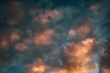 Plane in sunset clouds