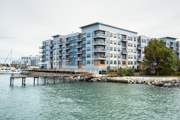 Waterside apartment complex with a private pier on a cloudy autumn day. Boston, MA, USA.