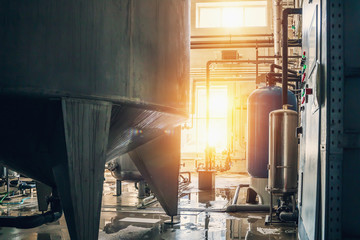 Reservoirs, tanks and pipes in modern beverage production plant or factory. Industrial background.