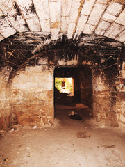 Mystic interior of an ancient dungeon. An old abandoned tunnel in an underground wine cellar....