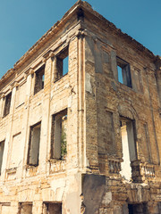 Mystical Interior, ruins of facade of an abandoned ruined building of an ancient castle 18th century. Old ruined walls, corridor with garbage and mud. Ruins Ancient historic building destroyed by war