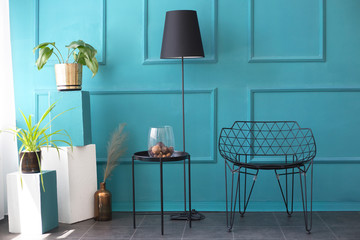 Living room design with turquoise wall and metallic black furniture