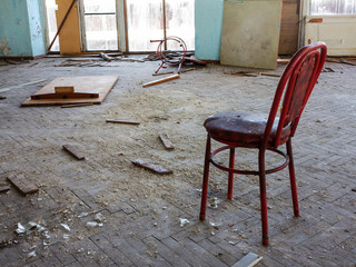 Old furniture scattered around the room. Interior details inside the destroyed house of culture. The interior of the dying abandoned cinema room.