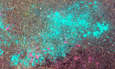 Creative background of asphalt surface with scattered on it with colored powders. To use as background for art design for any project.
