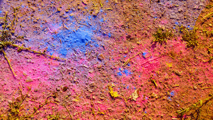 Creative background of asphalt surface with scattered on it with colored powders. To use as background for art design for any project.