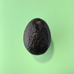 Simple avocado on green background