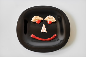 Funny food face, dumpling and ketchup