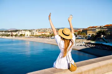 Papier Peint photo Nice Touristic picture of happy elegant woman posing back, put her hand in the air and enjoying amazing view in France Cannes beach, traveling goals, elegant glamour clothes, summertime.