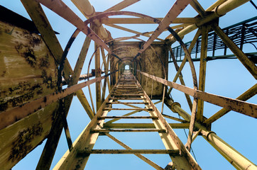 old high metal tower building with stairs bottom view