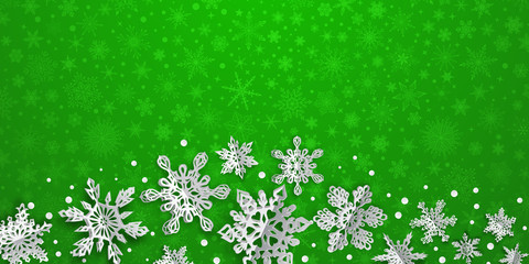 Christmas background with volume paper snowflakes with soft shadows on green background