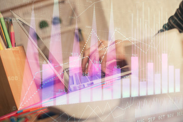 Double exposure of woman hands typing on computer and forex chart hologram drawing. Stock market invest concept.