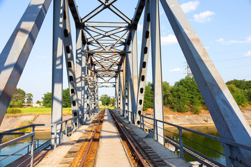 Railway bridge over the Pripyat river, Chernobyl. Metal structure, bridge supports. Bridge, years...