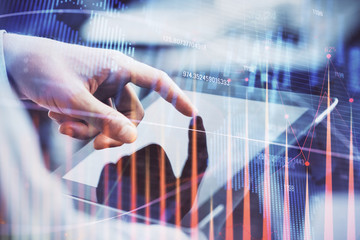Multi exposure of man's hands holding and using a phone and financial chart drawing. Market analysis concept.