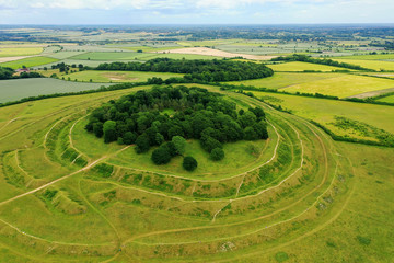 Aerial view of Badbury Rings in Dorset, United Kingdom. A historic Iron Age hill fort in east Dorset, England, which dates from around 800 BC and was in use until the Roman occupation of 43AD. - 371326013