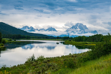 Fototapeta na wymiar Oxbow Bend in Grand Teton National Park is located just a little over a mile straight east of the Jackson Lake Junction on Highway 89. You can't miss it- it's where the Snake River gets extremely wide