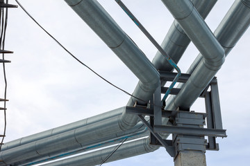 Fragment Metal grain elevator in agricultural zone. Agricultural Silos. Building Exterior. Storage and drying of grains, wheat, corn, soy, sunflower on background of cloudy sky. Agriculture.