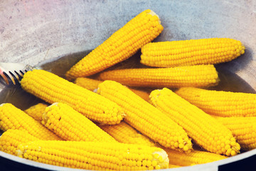 Corn on the cob. Sweet corn cooked in boiling water in a saucepan