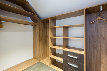 Fototapeta premium Empty storage room wardrobe cloakroom interior organization with shelving, hanging rails and shoe racks