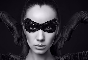 ?harming elegant brunette woman in sequins mask and gloves