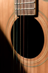 Close-up guitar with half sun highlight and shadow