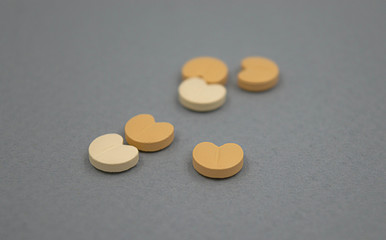Heart pills on grey background