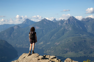 Adventurous Girl Hiking on top of Tin Hat Mountain, part of the popular Sunshine Coast Hiking Trail in Powell River, British Columbia, Canada. Concept: Explore, Adventure, Travel