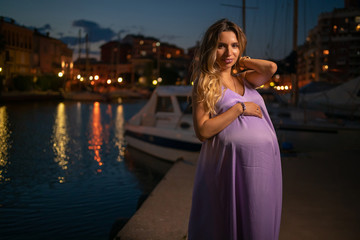 Happy pregnant girl in night marine 