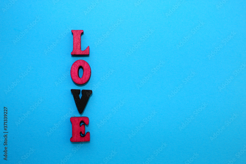 Fototapete the letters of the alphabet are laid out on a blue background in the form of a word.