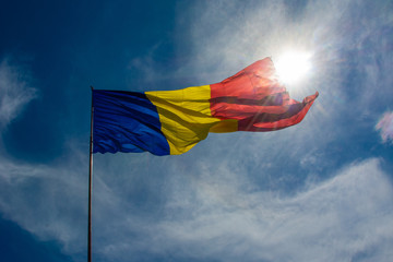 Romanian flag waving near the sun