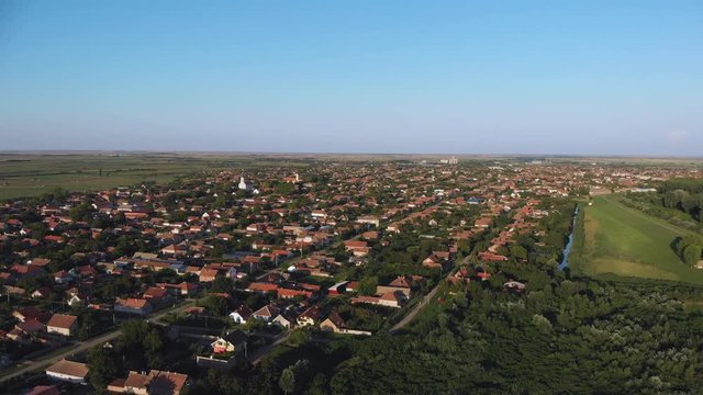Slow aerial rising view at sunset over the small town of Novi Becej in Serbia.