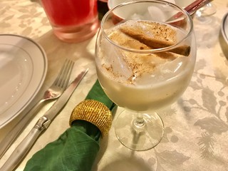 Christmas cocktail in a glass with cinnamon stick