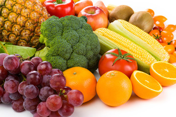 Close-up variety of fresh fruits and vegetables on bright background