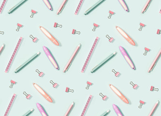 Creative seamless pattern with office supplies, color pencils, pens, puler, markers and metal paper clips. School and education concept.