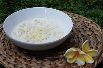 Macaroni soup with milk sauce and topped with grated cheese