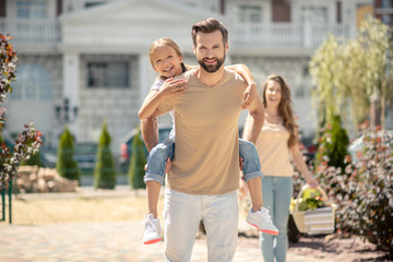 Beautiful young family walking and looking happy