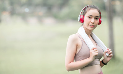 Young sportswoman with headphone preparing to run.
