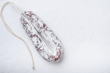 Salami sausage fuet on white background with space for text