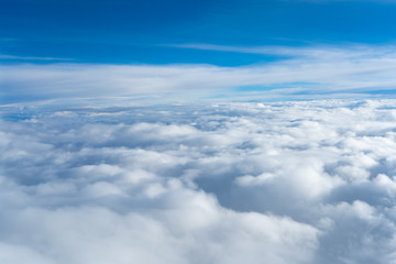 Fluffy clouds top view of the airplane. Heavenly landscape