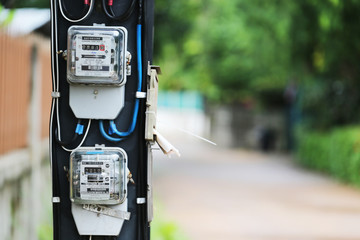 Outdoor electric meters & pole beside the local road with copy space taken by close - up photography
