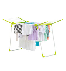 Clean clothes hanging on dryer against white background
