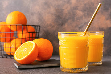 Glasses of fresh orange juice on table