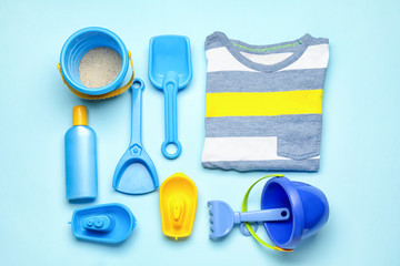 Set of beach accessories for children on color background