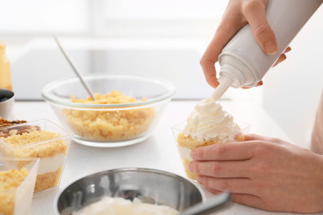 Woman preparing delicious cupcake in jar