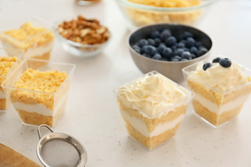 Delicious cupcakes in jars on table