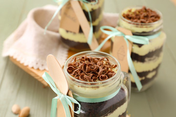 Delicious cupcake in jar on table, closeup