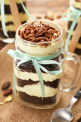 Delicious cupcake in jar on table