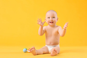 Portrait of cute little baby on color background
